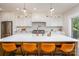 Open kitchen with a large island, modern lighting, white cabinets, stainless steel appliances, and wood floors at 594 Patterson Farm Rd, Mooresville, NC 28115