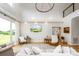 Bright living room with high ceilings, a modern chandelier, and a large wall-mounted television at 594 Patterson Farm Rd, Mooresville, NC 28115