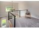 Cozy loft space with modern railing and neutral decor offers a relaxing atmosphere with natural lighting at 594 Patterson Farm Rd, Mooresville, NC 28115