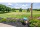 Lush green yard with a bird bath and garden against a partly cloudy sky at 594 Patterson Farm Rd, Mooresville, NC 28115