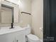 This half bathroom features a modern sink and fixtures along with clean lines at 616 W Marion St, Shelby, NC 28150