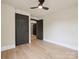 A bedroom with hardwood floors, black doors and trim, and a modern ceiling fan at 616 W Marion St, Shelby, NC 28150