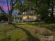Charming two-story home with a welcoming front porch, illuminated at dusk at 616 W Marion St, Shelby, NC 28150