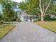 Charming two-story home with a gravel driveway and a welcoming front porch at 616 W Marion St, Shelby, NC 28150