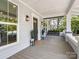 Inviting front porch with porch swing and stylish exterior lighting at 616 W Marion St, Shelby, NC 28150