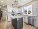 Kitchen features white cabinets, stainless steel appliances, gold hardware, and marble countertops at 616 W Marion St, Shelby, NC 28150