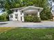 Two-story home with a covered porch and gravel yard at 616 W Marion St, Shelby, NC 28150