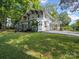 Two-story home with a deck and carport, surrounded by a lush lawn at 616 W Marion St, Shelby, NC 28150