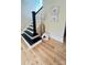 Classic staircase with black and white accents adds elegance to the entryway at 616 W Marion St, Shelby, NC 28150