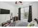 Cozy bedroom with a large window, stylish curtains, and a comfortable bed with decorative pillows at 630 Calvert St # 410, Charlotte, NC 28208