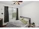 Comfortable bedroom with a large window offering natural light, complemented by neutral decor at 630 Calvert St # 410, Charlotte, NC 28208