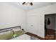 Simple bedroom featuring hardwood floors, a comfortable bed, and closet with double doors at 630 Calvert St # 410, Charlotte, NC 28208