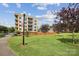 Modern apartment building with balconies overlooking a well-maintained green space, perfect for urban living at 630 Calvert St # 410, Charlotte, NC 28208