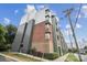 Modern apartment building with a mix of brick, gray, and green siding and sidewalks at 630 Calvert St # 410, Charlotte, NC 28208