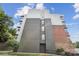 Modern apartment building exterior features a mix of brick, gray, and silver siding, plus a ramp at 630 Calvert St # 410, Charlotte, NC 28208