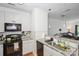 Bright kitchen boasts granite counters, a black range, and stainless steel pendant lighting at 630 Calvert St # 410, Charlotte, NC 28208