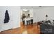 Open floor plan features hardwood floors connecting the living room, kitchen, and dining area at 630 Calvert St # 410, Charlotte, NC 28208