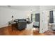 Spacious living room with a comfortable sectional sofa, desk, and a view of the balcony at 630 Calvert St # 410, Charlotte, NC 28208