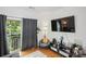 Comfortable living room featuring a balcony with natural light, a beanbag chair, and a large TV at 630 Calvert St # 410, Charlotte, NC 28208