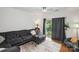 Cozy living room features a plush gray sectional sofa, area rug, and balcony access at 630 Calvert St # 410, Charlotte, NC 28208