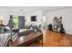 Open-concept living room with hardwood floors, comfortable sofas, and a balcony with natural light at 630 Calvert St # 410, Charlotte, NC 28208