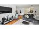 Inviting living room with hardwood floors, large TV, and comfortable seating arrangement at 630 Calvert St # 410, Charlotte, NC 28208