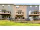 Backyard view of townhomes, each with a private balcony, patio, and fenced yard with green grass at 6507 Revolutionary Trl, Charlotte, NC 28217