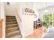Inviting entryway with staircase, hall tree, and breakfast nook with sliding glass doors to the outdoor deck at 6507 Revolutionary Trl, Charlotte, NC 28217