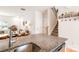 Kitchen sink and granite countertop overlook the staircase, living room, and dining space at 6507 Revolutionary Trl, Charlotte, NC 28217