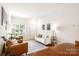 Cozy living room with a white sofa, natural light, a decorative rug, and warm leather seating at 6507 Revolutionary Trl, Charlotte, NC 28217