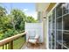 Relaxing outdoor deck area with rocking chair overlooking lush greenery and trees for shade at 6507 Revolutionary Trl, Charlotte, NC 28217