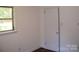 Bedroom view highlighting a bright window and closet door with neutral paint and hardwood floors at 761 Henry Rhodes Rd, Lincolnton, NC 28092