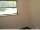Bedroom close-up featuring a bright window and neutral paint and hardwood floors at 761 Henry Rhodes Rd, Lincolnton, NC 28092