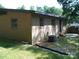A single-story brick home featuring a small patio area and a well-kept lawn at 761 Henry Rhodes Rd, Lincolnton, NC 28092