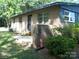A brick home featuring a small patio area with green shrubs and side entry at 761 Henry Rhodes Rd, Lincolnton, NC 28092