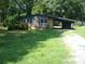 Charming single-story home featuring a brick facade, covered parking, and a spacious front yard at 761 Henry Rhodes Rd, Lincolnton, NC 28092