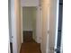 Hallway with hardwood floors leading to bright rooms, showcasing a well-maintained interior at 761 Henry Rhodes Rd, Lincolnton, NC 28092