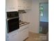 Traditional kitchen showcasing bright cabinets, stainless hood, and neutral countertops at 761 Henry Rhodes Rd, Lincolnton, NC 28092