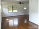 Bright living room features hardwood floors, white walls, large windows, and ample natural light at 761 Henry Rhodes Rd, Lincolnton, NC 28092