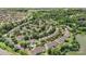 Aerial view of home in a lush, green neighborhood with mature trees and easy access to a pond at 825 Rock Lake Gln, Fort Mill, SC 29715