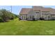 Grassy backyard featuring a patio and a gray house at 825 Rock Lake Gln, Fort Mill, SC 29715