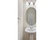 Bathroom showing a pedestal sink with an oval mirror and a wall mounted towel ring at 825 Rock Lake Gln, Fort Mill, SC 29715