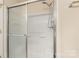 Bathroom with a glass door shower, white tiles and metal fixture at 825 Rock Lake Gln, Fort Mill, SC 29715