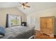 Comfortable bedroom with vaulted ceiling features a window and wooden cabinet for storage at 825 Rock Lake Gln, Fort Mill, SC 29715