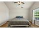 Bright bedroom featuring a ceiling fan, and large window allowing natural light to fill the space at 825 Rock Lake Gln, Fort Mill, SC 29715