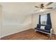 Bright bonus room featuring hardwood floors, ceiling fan, and natural light from the window at 825 Rock Lake Gln, Fort Mill, SC 29715