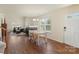 Open-concept dining area featuring hardwood floors, a cozy fireplace, and easy access to the living room at 825 Rock Lake Gln, Fort Mill, SC 29715