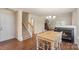 Inviting dining area with hardwood floors, staircase, and fireplace, flowing into the living space at 825 Rock Lake Gln, Fort Mill, SC 29715
