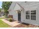 A welcoming entryway with a classic black door, well-maintained siding, and neat landscaping at 825 Rock Lake Gln, Fort Mill, SC 29715
