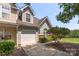 Charming townhome with a one-car garage, complemented by manicured landscaping and a welcoming facade at 825 Rock Lake Gln, Fort Mill, SC 29715